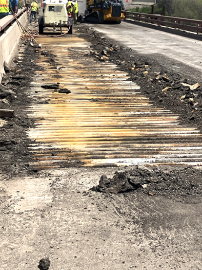 Asphalt lane cleared from bridge