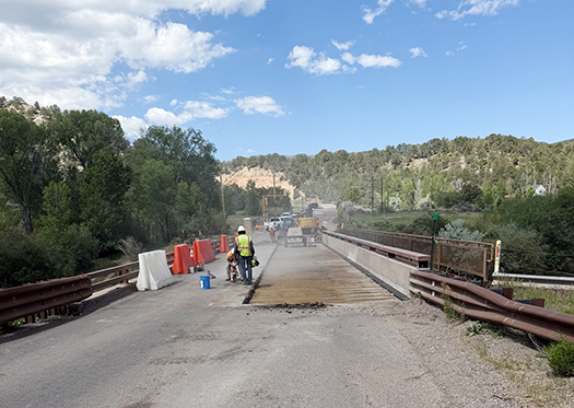 Workers prepare the County Road 108 bridge near Carbondale for new decking.