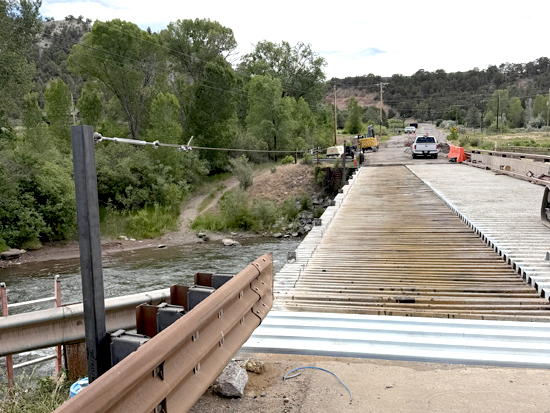 Thompson Creek bridge south side asphalt and curb removed for decking installation