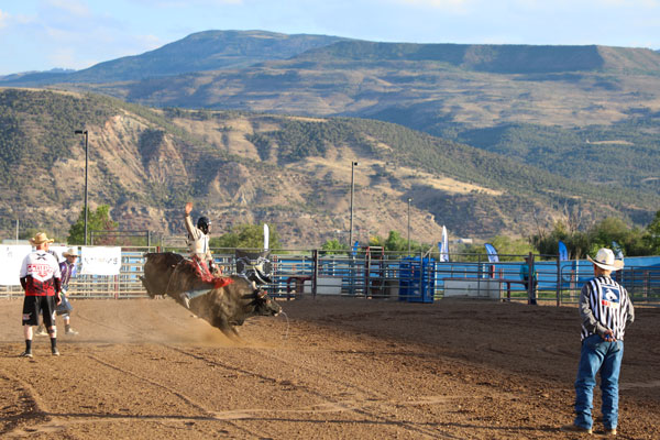 A cowboy rides a bulls at the Garfield County Fairgrounds in Rifle. 